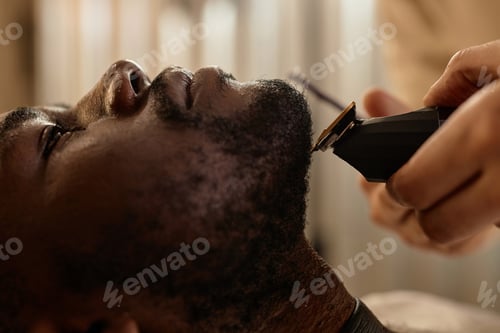 Preview: Man shaving beard in barber shop
