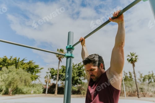 Preview: A man is holding a high bar at a calisthenics gym during a workout ready to do pull ups