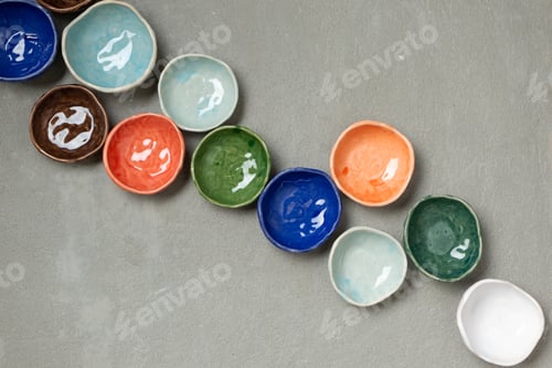 Preview: Handmade colorful ceramic empty dishes and plates on concrete background