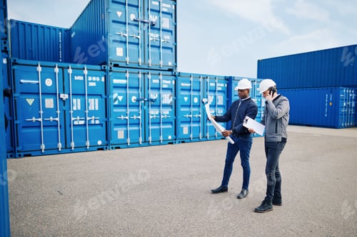 Preview: Two engineers standing in a freight yard discussing building plans