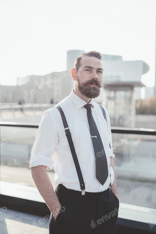Preview: Portrait of stylish businessman with hands in pockets in city