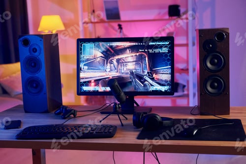 Preview: Close up view of microphone. PC at home with shooter game launched on