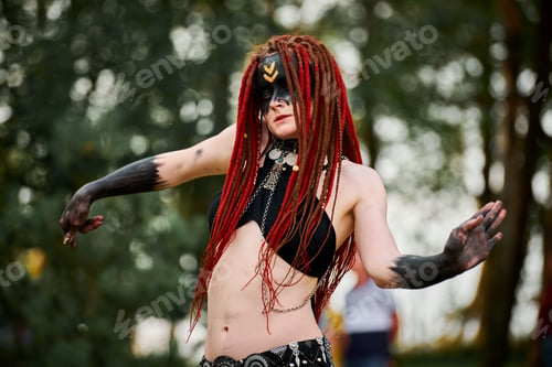 Preview: Mythological dancing girl faun on green lawn in public park outdoor art dancing event