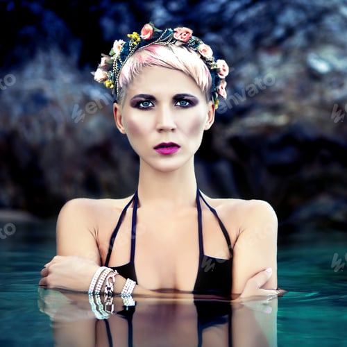 Preview: sensual girl in a wreath of flowers in the sea