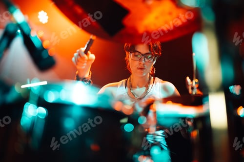 Preview: Drummer playing drums during live performance on stage