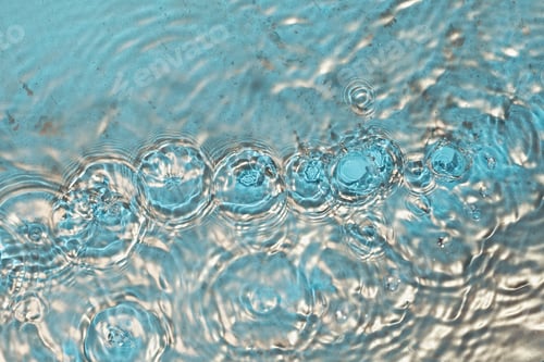 Preview: Cosmetic moisturizer micellar water. Gold powder particles forms on water surface. Abstract liquid