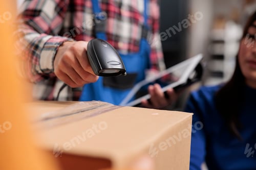 Preview: Retail storehouse employees doing inventory management while scanning packages