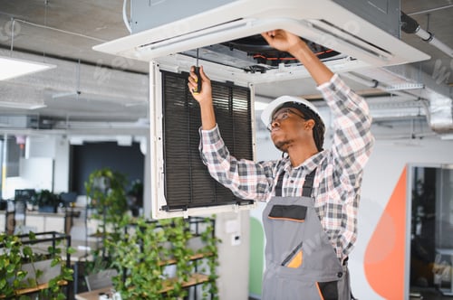 Preview: Technician repairing air conditioning system in office building