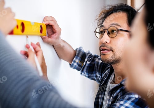 Preview: Asian couple measuring the wall
