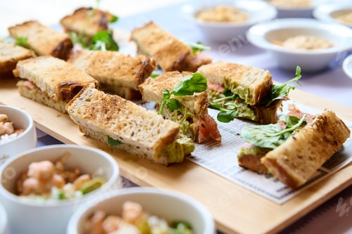 Preview: sandwiches with salmon, cheese and lettuce on a wooden board