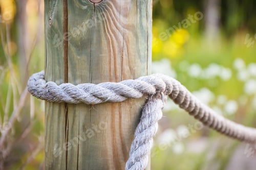 Preview: Fence made of rope and wooden pole in park
