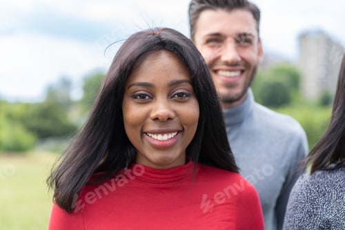 Preview: Smiling Young Woman with Friends Outdoors