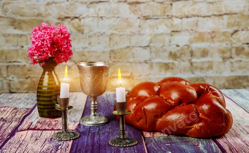 Preview: Traditional Jewish Sabbath Shalom ritual fresh challah bread with kiddush cup of red kosher wine