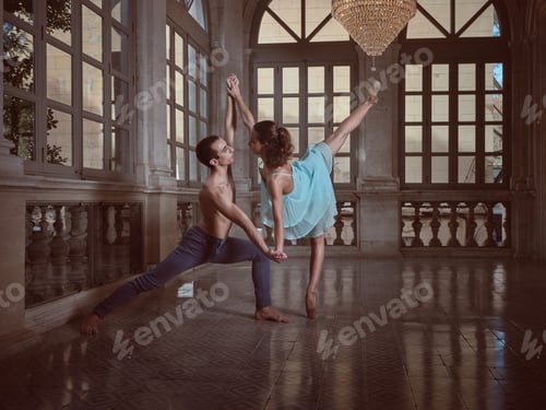 Couple dancing ballet in spacious hall