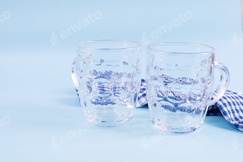 Preview: Oktoberfest background. Beer mug and Bavarian symbolic fabric