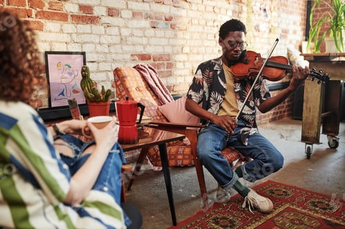 Preview: Guy in stylish casualwear of 90s playing violin while sitting in armchair