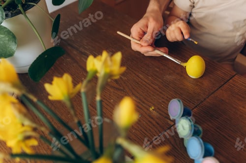 Preview: dad and child decorating eggs for Easter