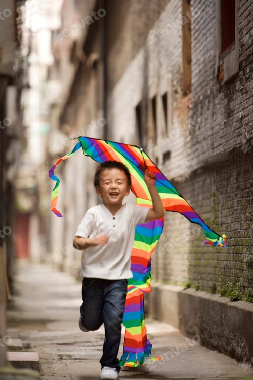 Preview: A child runs with a kite.