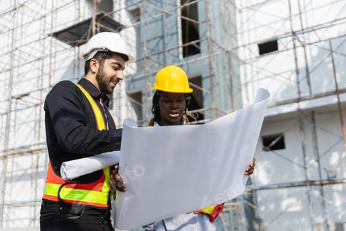 Preview: Construction civil engineer man and woman African American checking quality of work in construction
