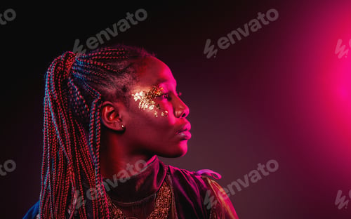 Preview: Young African woman with afro hairstyle. Studio shot. Blue and pink neon light flare.