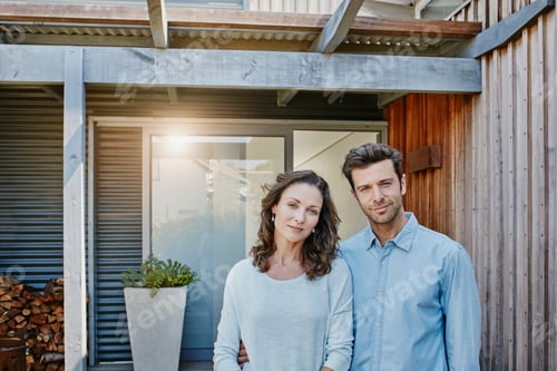 Aperçu: Couple standing in front of door of their home