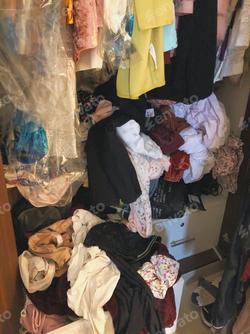 Preview: Messy wardrobe with clothes tucked away