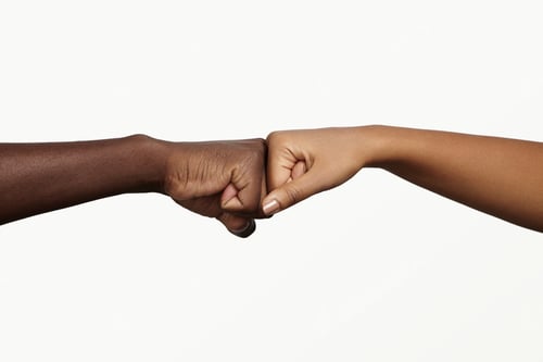 Preview: African man touching knuckles with dark-skinned woman as sign of agreement, partnership and cooperat