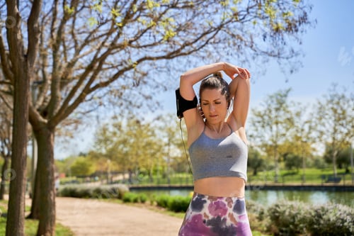 Preview: Woman Stretching in a Park on a Sunny Day