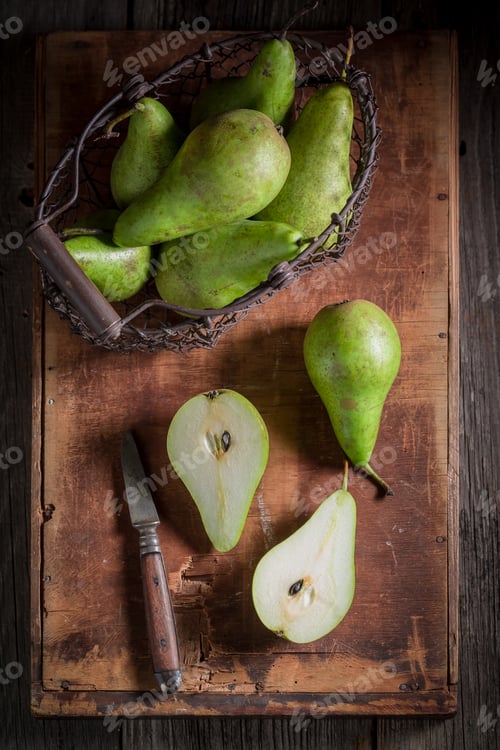 Preview: Green Pears in an old wire basket on wooden box