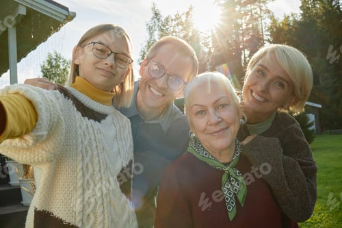Preview: Portrait of Family Smiling Outdoors during Sunny Autumn Day