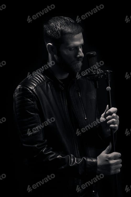 Preview: One Man Singing On A Microphone, Eyes Closed, Emotional. Black And White Image.