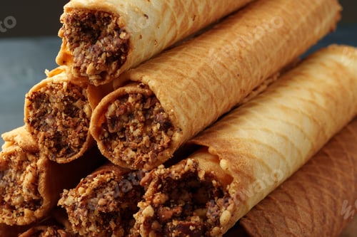 Preview: Waffle tubes with chocolate filling on wooden board