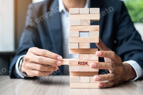 Preview: Businessman hand placing or pulling wooden block on the tower. Business planning, Risk Management,