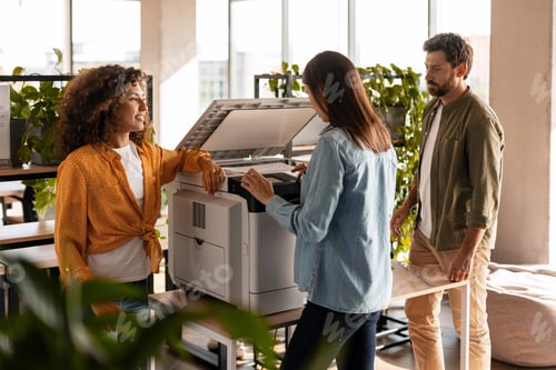 Preview: Business team troubleshooting modern office printer issues