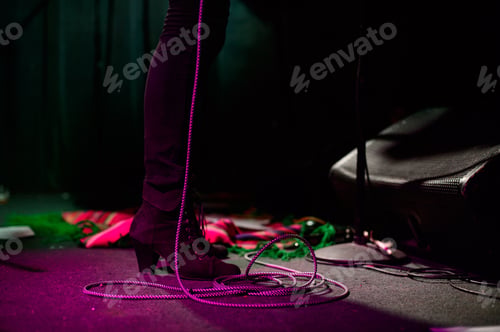 Preview: Woman's legs standing on stage.