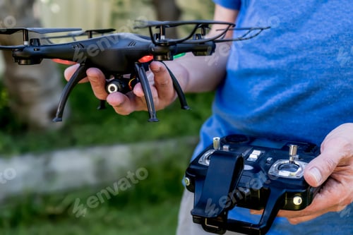 Preview: Man holding Camera drone and the remote. Drone photography
