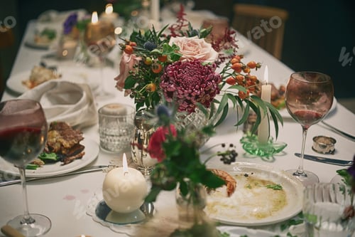Preview: Cozy dinner setting aftermath with wine glasses and floral centerpiece