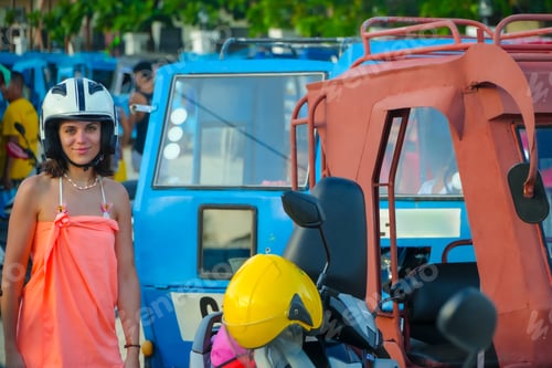 Preview: Tourist wearing helmet standing next to tricycles in siargao island, philippines