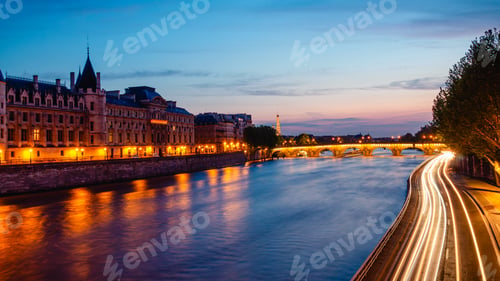 Preview: View of Paris by night with the Seine river and the Conciergerie building