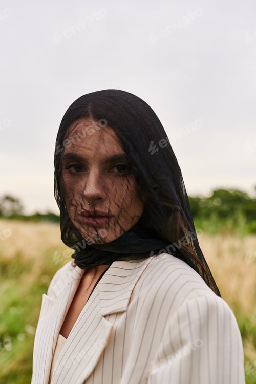Preview: Elegance in nature: woman in white suit and black scarf
