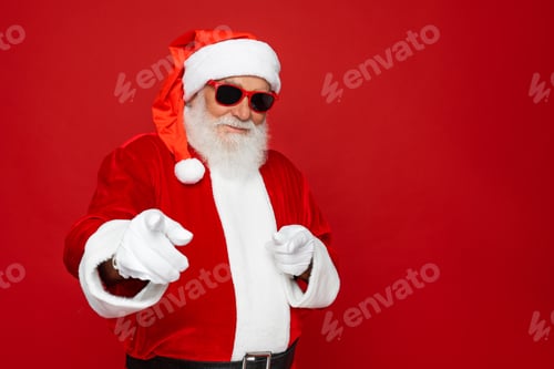 Preview: Happy Santa Claus finger gesture choosing you for advertising isolated on red background