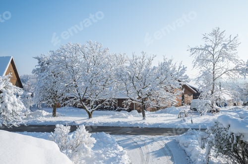 Preview: Country house and snow covered garden on a cold day morning