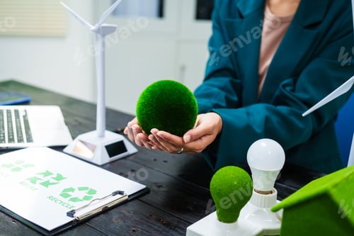 Preview: An Asian businesswoman sits at her desk, discussing clean energy solutions their impact on homes