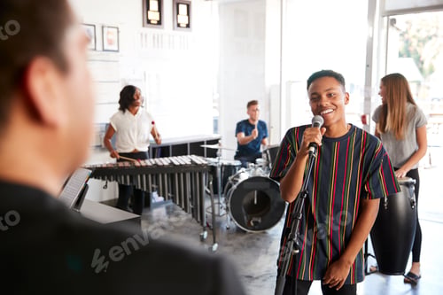 Preview: Students At Performing Arts School Playing In Band At Rehearsal With Teacher