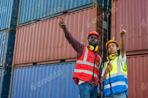 Preview: Foreman control loading Containers box from Cargo freight ship for import export.