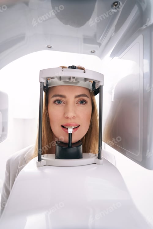 Preview: Woman using dental diagnostic equipment in clinic