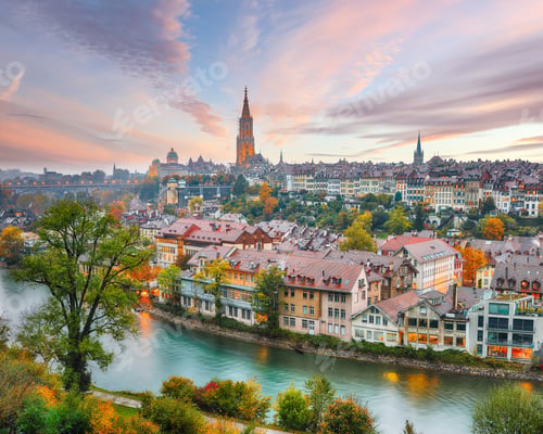 Preview: Fabulous autumn view of Bern city on Aare river during evening with Cathedral of Bern on background