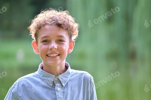 Preview: Young happy child boy relaxing in summer park.