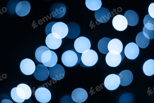 Preview: Abstract blue bokeh lights glow on black. Holiday concept