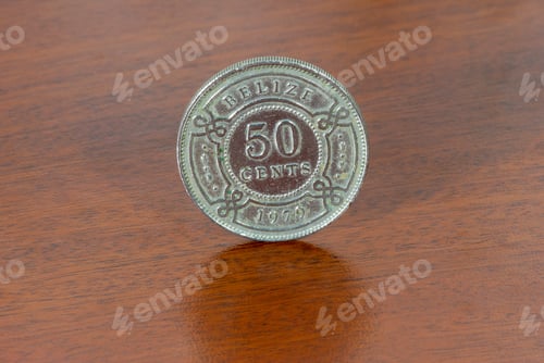Preview: Belize coin 50 cents of 1979, currency over wood texture.